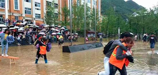 Students slammed as 'lazy' after female sanitation workers carry scholars over flooded campus