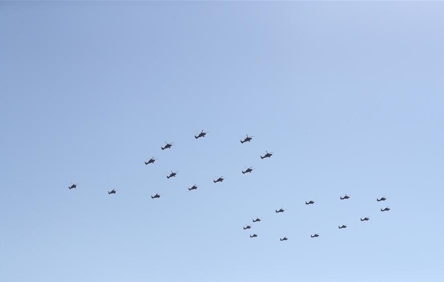 Xi reviews parade in field for first time