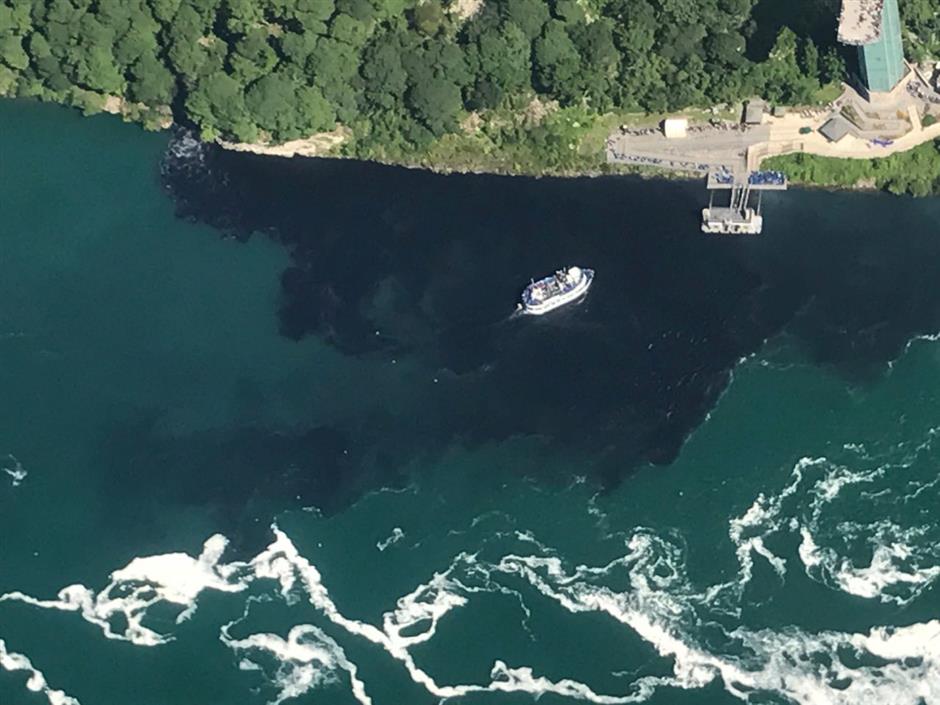 Discharge turns water at base of Niagara Falls black