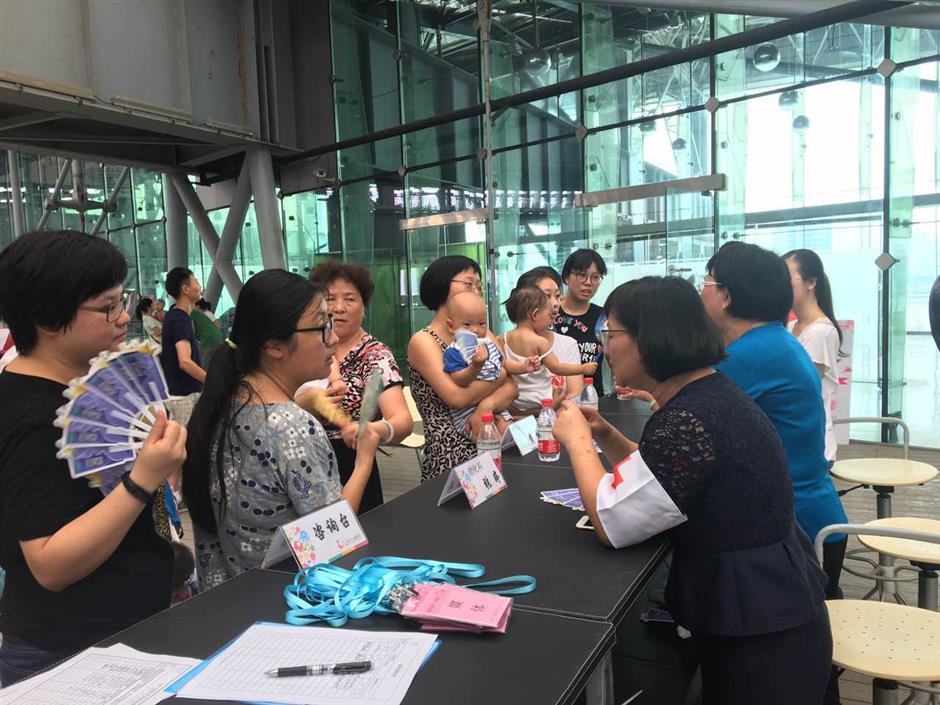 Moms nurse babies in a public breastfeeding flash mob