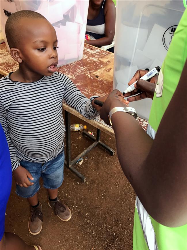 Some Kenyans, keen to vote, rent babies to jump long queues