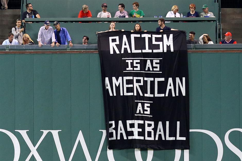 Campaigners unveil banner linking racism and baseball at Red Sox game