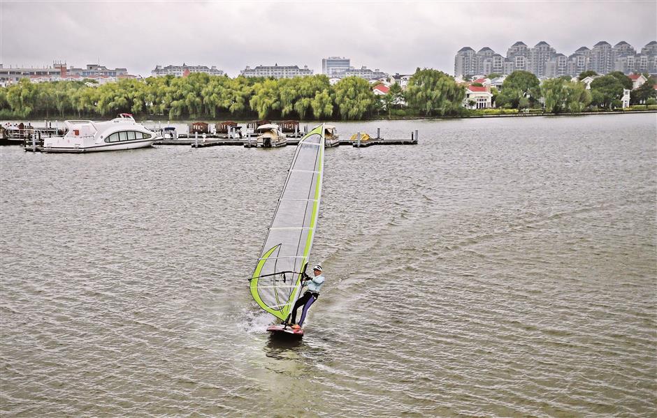 Retiree swaps the workplace to become a windsurfing beach boy