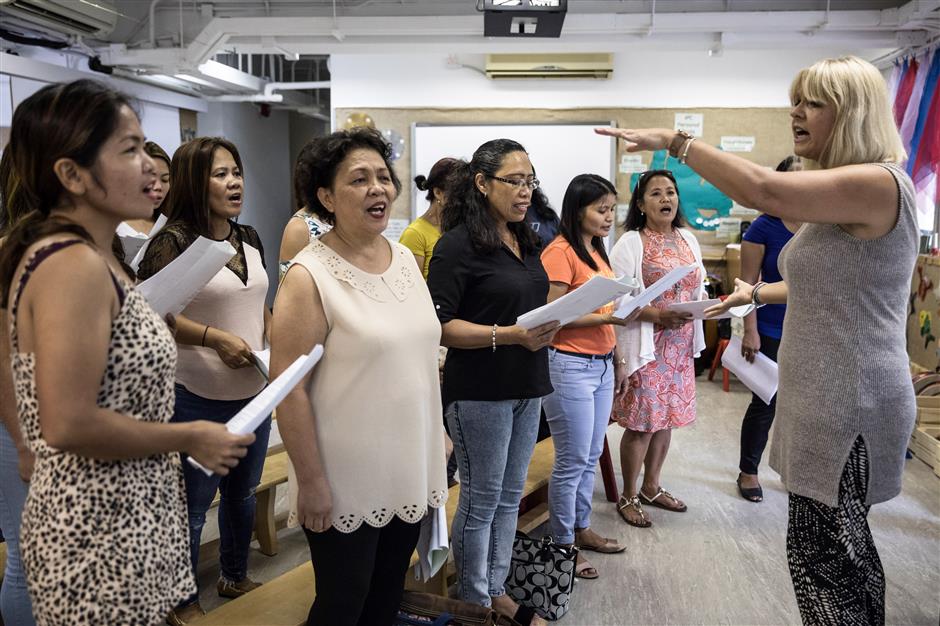 Hong Kong migrant mothers sing for their distant children