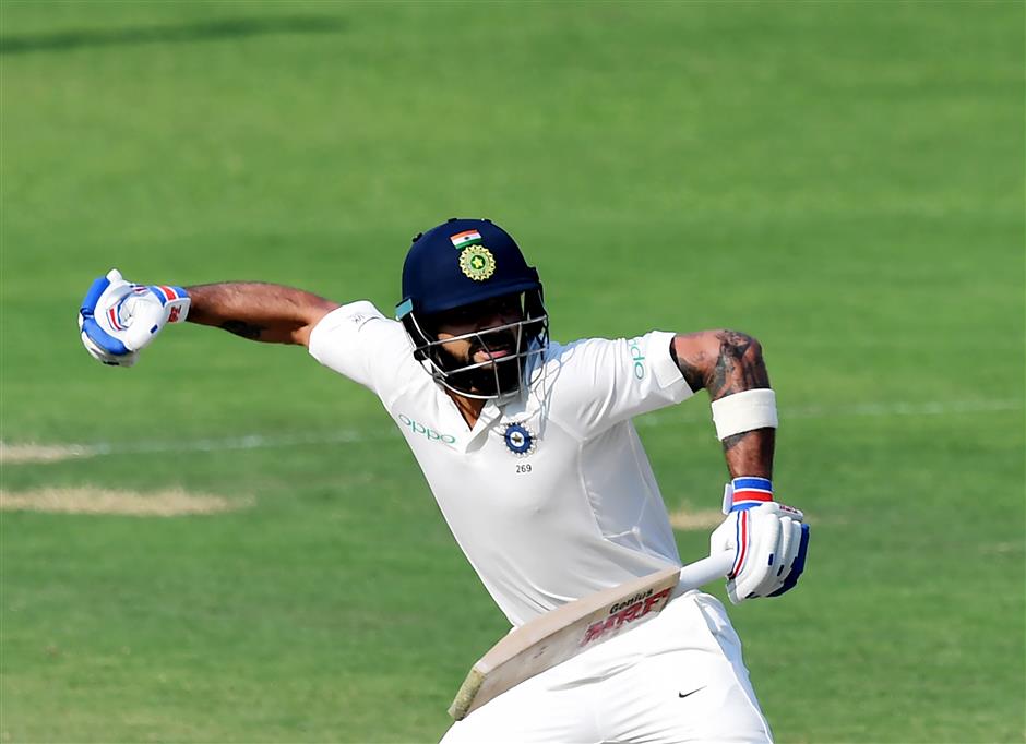 Kohli hits 50th century as Sri Lanka clings on for draw in first test