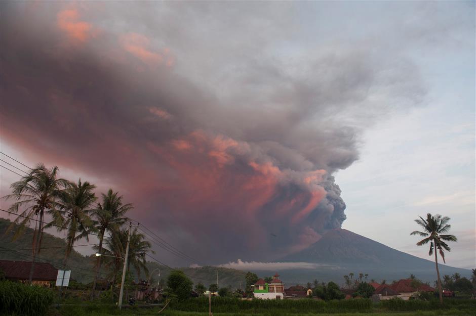 Bali volcano spews smoke and ash, disrupting flights