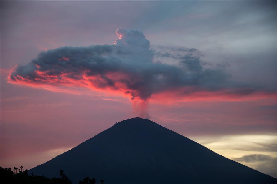 Tourists leave as Bali's volcano-hit airport gets back to business