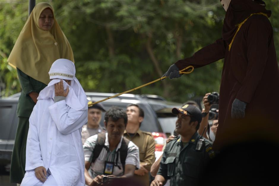 Indonesians whipped over sharia-banned children's play