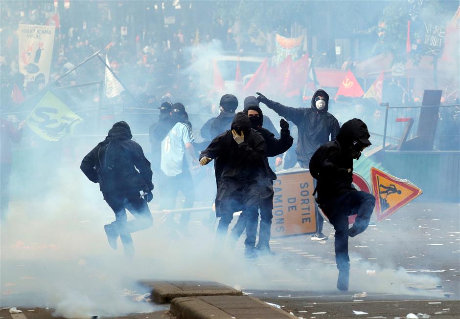 Masked men smash shops, torch cars during Paris May Day rally