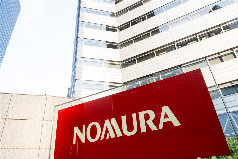 Japanese securities trader Nomura plans to set up holding firm in China