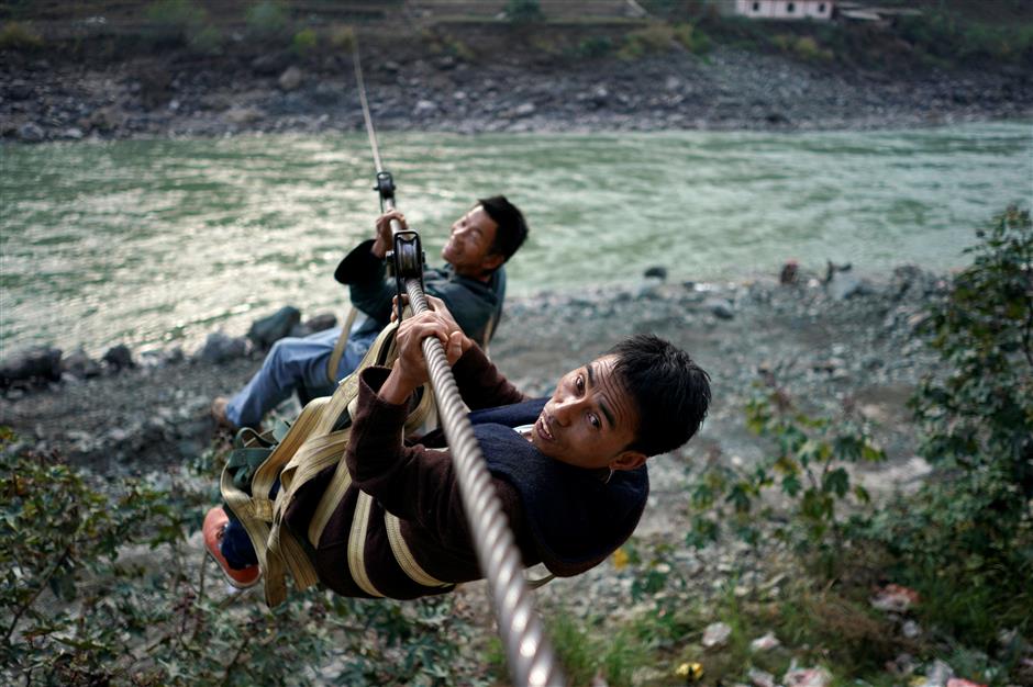 Just zipping out to the shops: Mountain dwellers soar over angry rapids in China