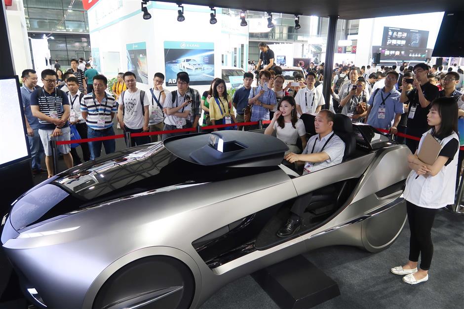 Automakers drive to promote self-driving cars at CES Asia