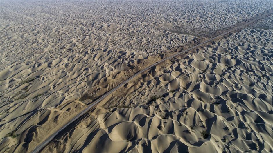 Third desert road under construction in Taklimakan desert in NW China's Xinjiang