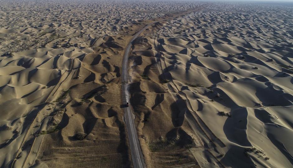 Third desert road under construction in Taklimakan desert in NW China's Xinjiang