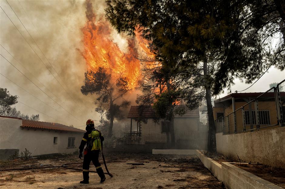 Wildfires kill at least 74 near Athens, families embrace as flames close in