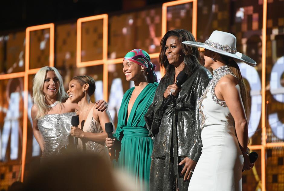 Women reign at glitzy Grammys gala that also makes rap history