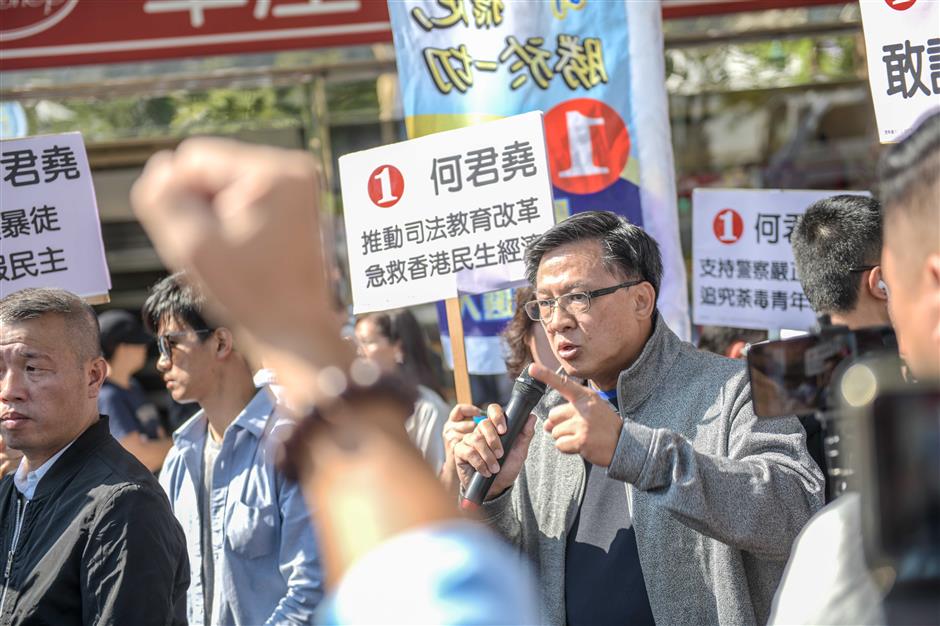 Stabbed HK candidate returns to campaigning