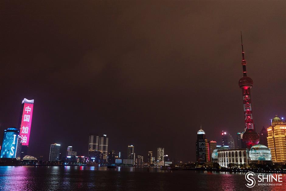 Both sides of the Huangpu River light up in support of Wuhan