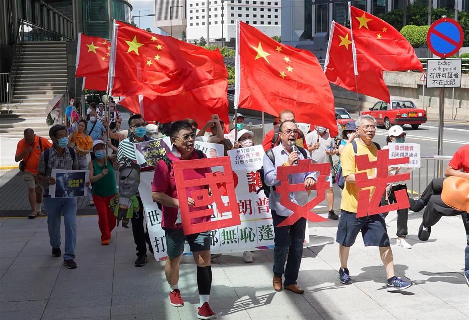 China's top legislature adopts law on safeguarding national security in Hong Kong, adds it to Basic Law annex