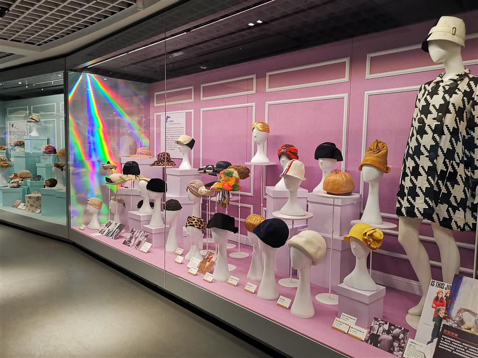 Hats and garments displayed to charter fashion's evolution throughout history